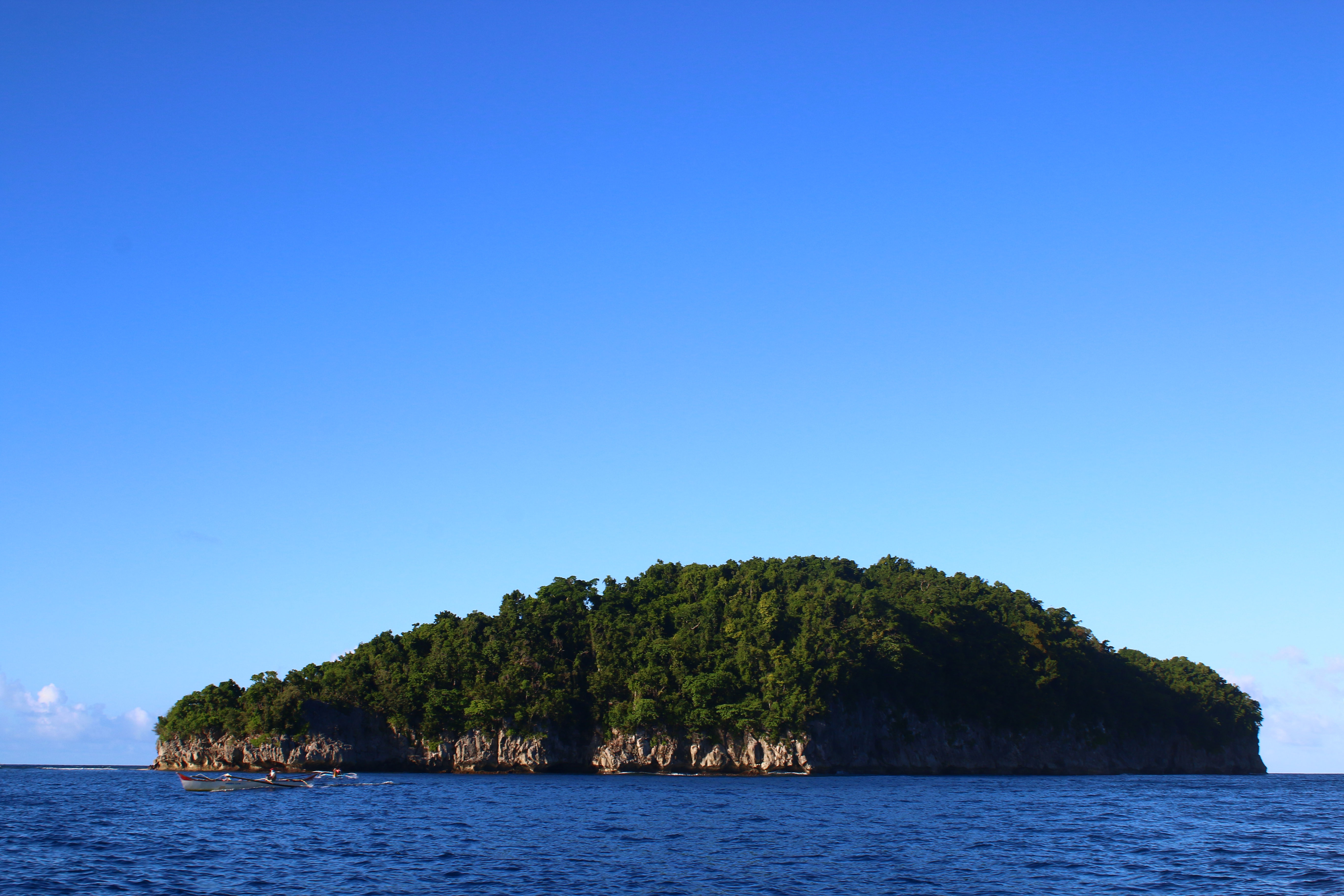 <b class="font-bara"><i class="bi bi-geo-fill h4"></i> MANCAGANGI ISLAND</b> <br/>A haven of bats and other wildlife, this huge limestone formation is located on the northeast of the City. It can be reached by boat within forty-five minutes. Relaxing cruise to the island will allow the tourists to appreciate the dramatic ocean sceneries and experience the fun as they triumph over rushing waves. The island has a perfect white-sand beach that gives way to emerald waters and animate corals. However, it is not advisable to go to the island on rainy seasons. Accessibility, only by boat, thus depends on the weather condition and tide.